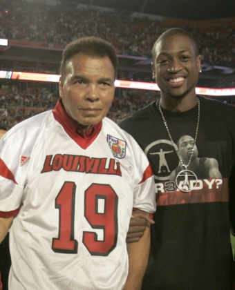 Muhammad Ali with Dwayne Wade on the field of a football arena