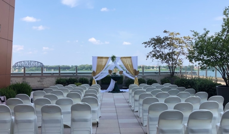Outdoor pavilion set up for a wedding with chairs and a focal area