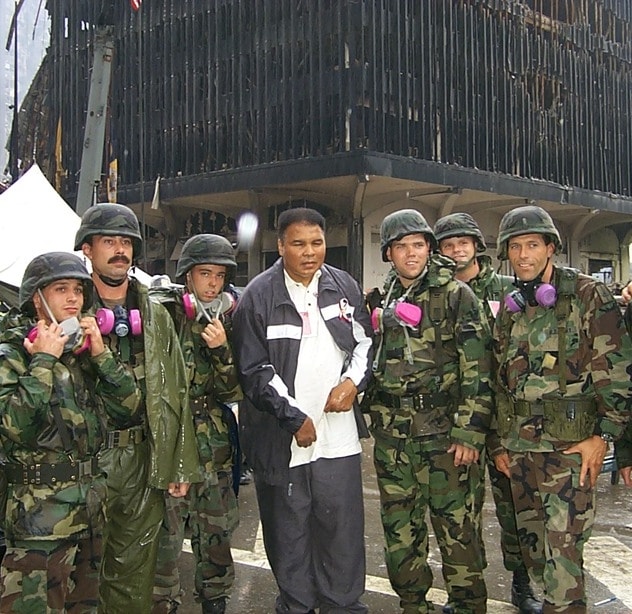 Color photo of Muhammad Ali with soldiers at Ground Zero one week after 9/11.