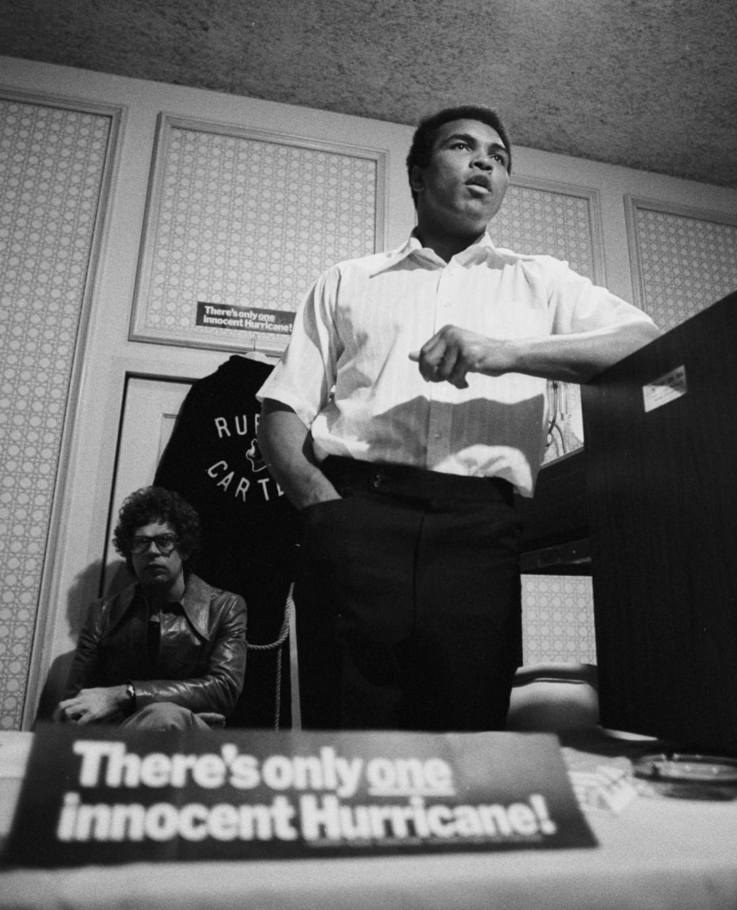 Black and white photo of Muhammad Ali speaking at event for release of Rubin "Hurricane" Carter