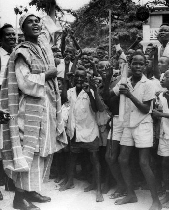 Historical photo of a Muhammad Ali as a young man in Nigeria with a group of boys and young men