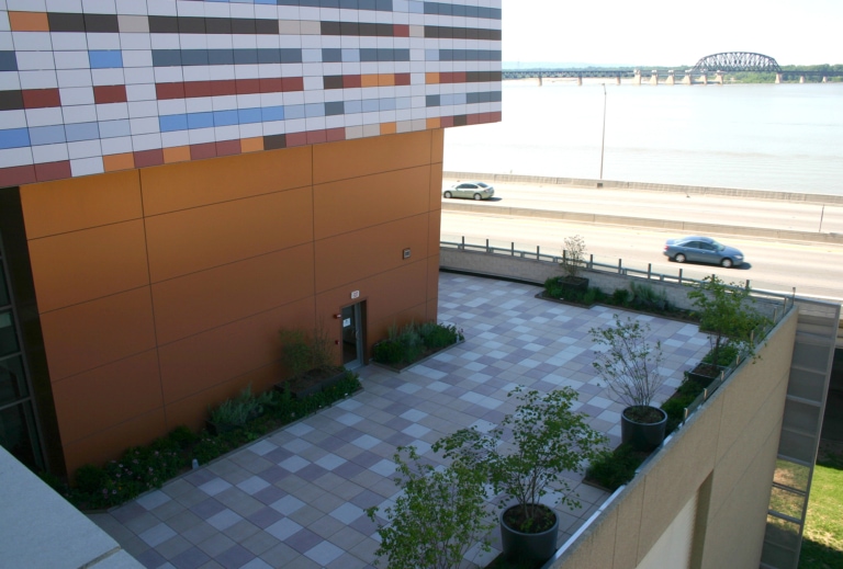 High perspective view of a large patio area at the Muhammad Ali Center next to a copper exterior wall