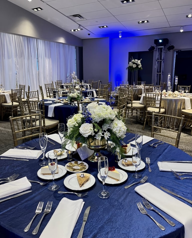 Event space with banquet rounds and chairs decorated for an event