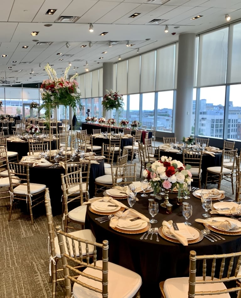 Event space with banquet rounds and chairs decorated for a wedding reception