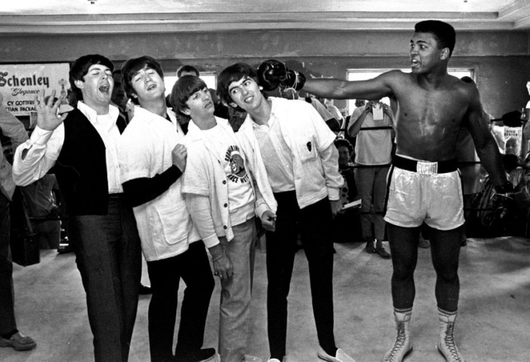 Black and white photo of Muhammad Ali and the members of the Beatles