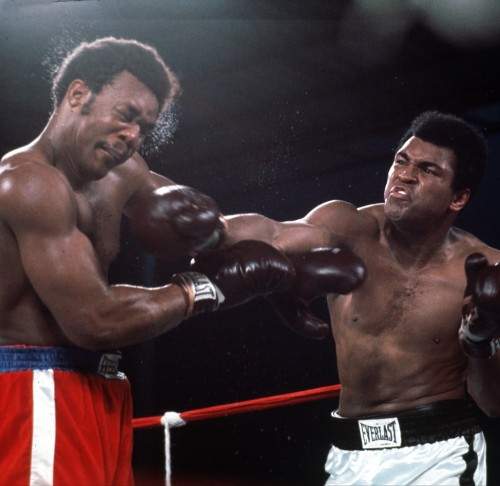 Action shot of Muhammad Ali punching George Foreman