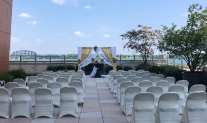 Outdoor pavilion set up for a wedding with chairs and a focal area