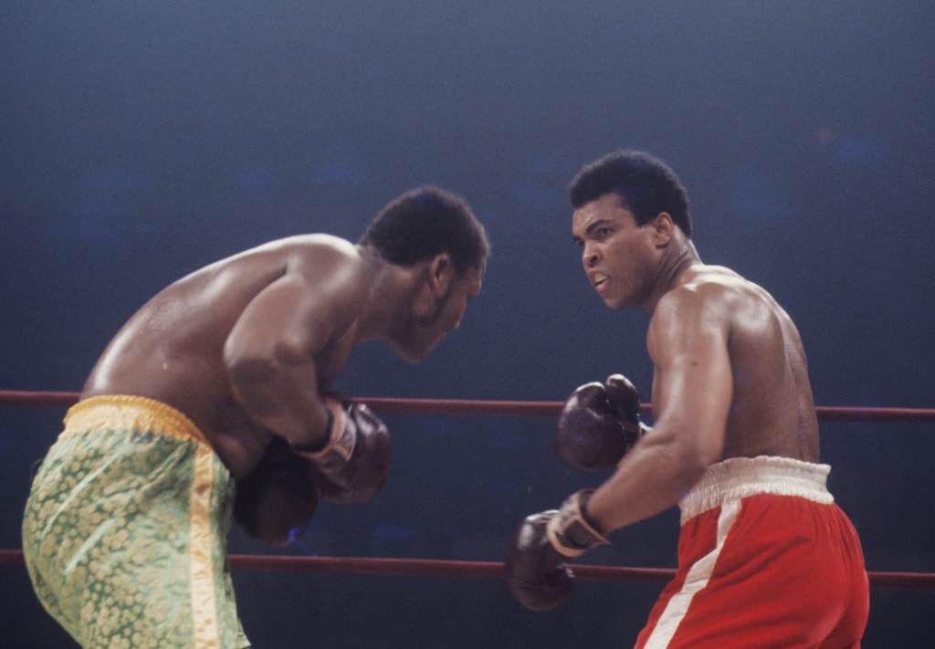 Action photo of Muhammad Ali and Joe Frazier during boxing match