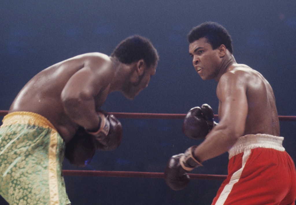 Action photo of Muhammad Ali and Joe Frazier during boxing match