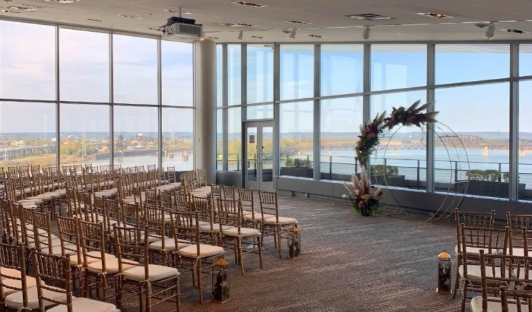 View Pointe Hall with chairs set up for a wedding and views of the river out the windows