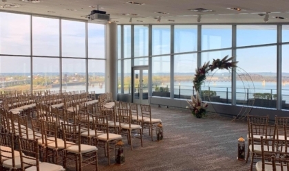 View Pointe Hall with chairs set up for a wedding and views of the river out the windows