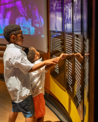 Two children pointing at exhibit inside Ali Center