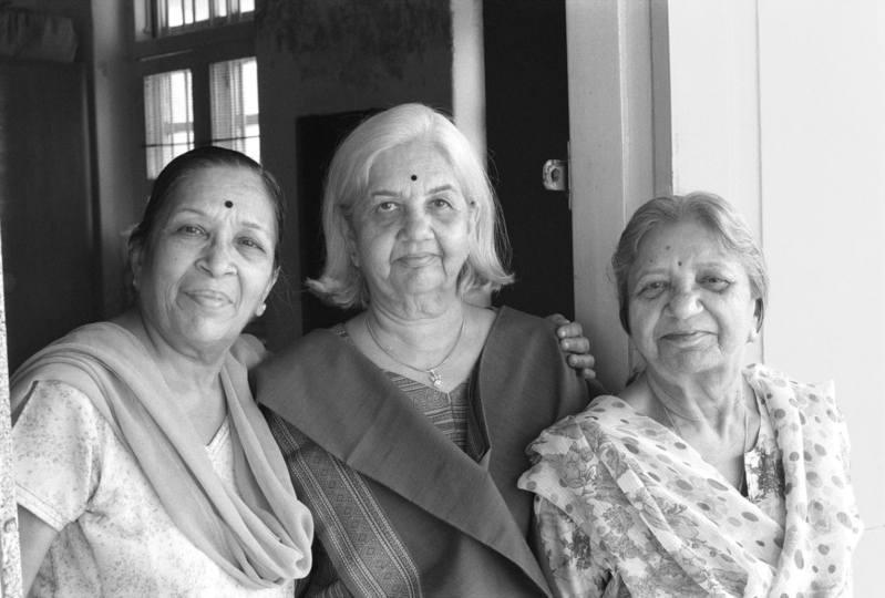 Photo of three women looking and smiling at camera
