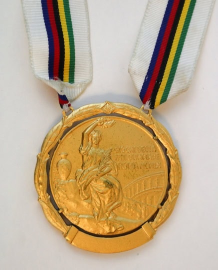 Picture of Gold Medal with white, red, green, and yellow ribbon