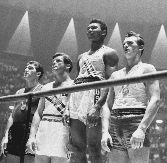 Picture of Muhammad Ali and three other boxers standing inside boxing ring