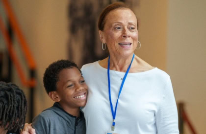 Lonnie Ali and young man smiling at camera for picture