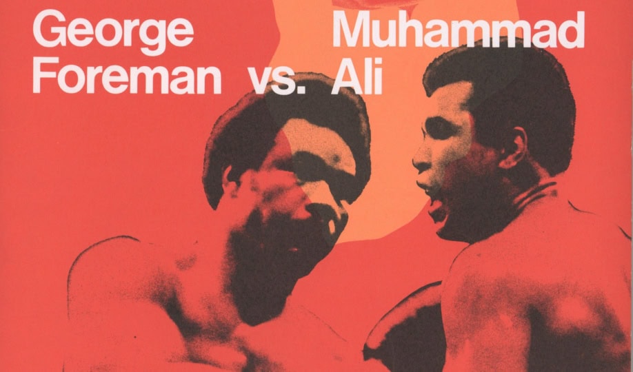 Red and orange poster featuring images of Ali and Foreman and outline of Africa with text "George Foreman v. Muhammad Ali"