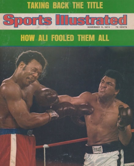 Photo of Sports Illustrated cover with image of Muhammad Ali and George Foreman in boxing ring with Ali throwing punch at Foreman