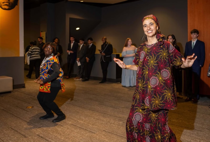 Photo of woman in red dress mid-dance pose