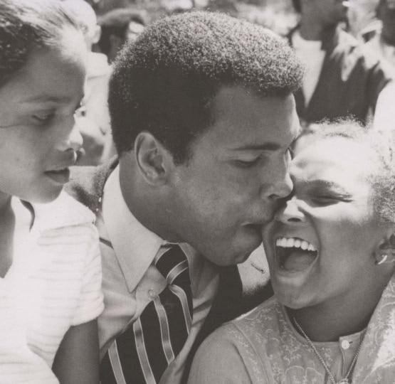 Black and white photo of Muhammad ALi with his daughters, Rasheeda and Maryum