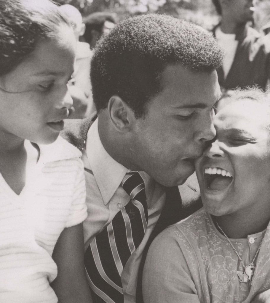 Black and white photo of Muhammad ALi with his daughters, Rasheeda and Maryum