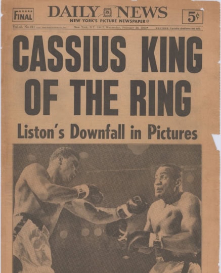 Scan of Daily News newspaper featuring image of Ali and Liston boxing with headline "Cassius King of the Ring"
