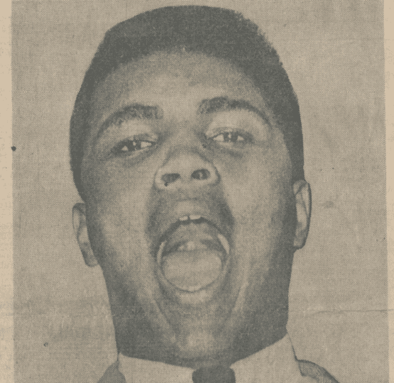 Black and white photo of Muhammad Ali on newsprint looking at camera with mouth wide open