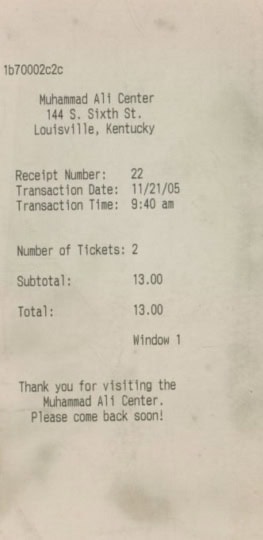 Two Muhammad Ali Center stickers featuring classic logo of Muhammad's face in silhouette alongside receipt dated 11/21/05 showing two tickets sold