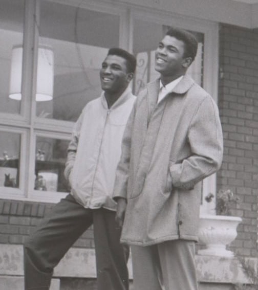 Home - Muhammad Ali Center Photo of Rahaman and Muhammad standing outside house on porch steps looking in the sky