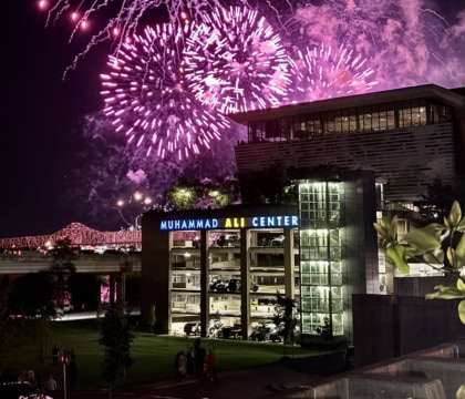 Muhammad Ali Center building with purple fireworks in background