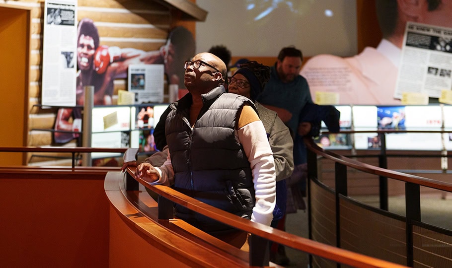 Ali Center museum visitor looking at exhibits