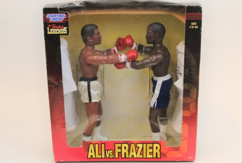Photo of two action figures depicting Muhammad Ali and Joe Frazier inside a box