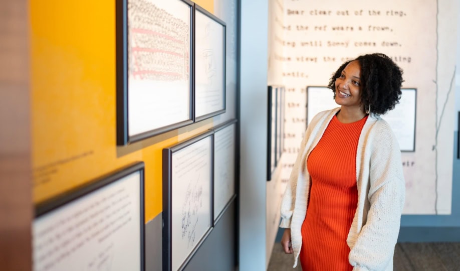 Woman viewing Muhammad Ali's art in a gallery
