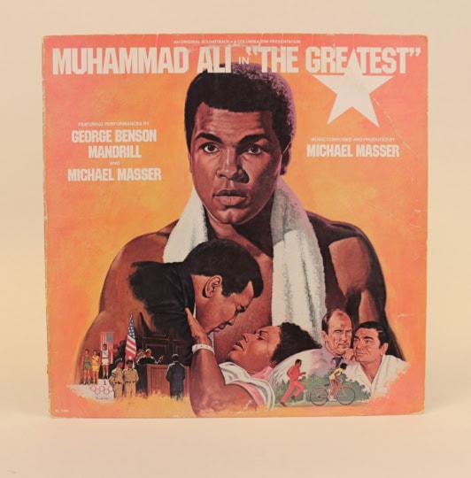 Vinyl album of "The Greatest" film featuring artwork of Muhammad Ali's life events
