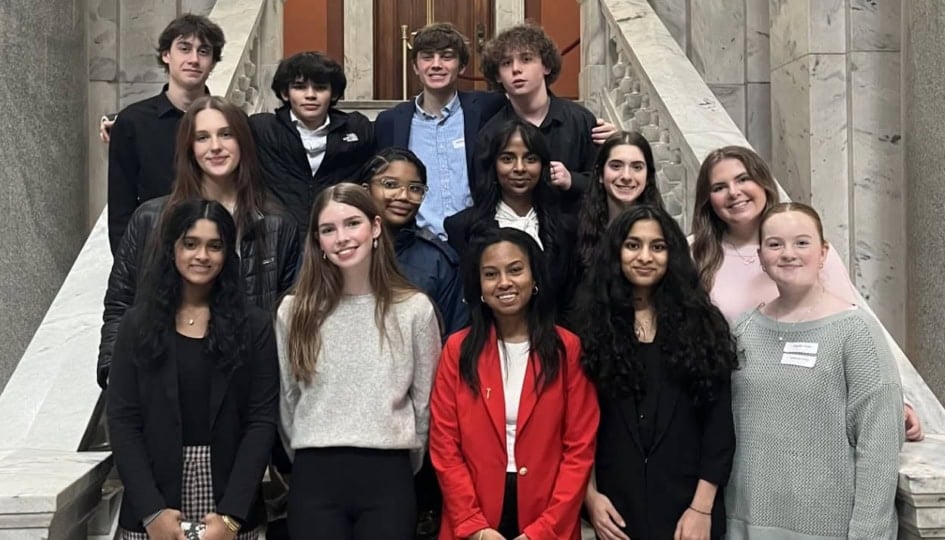 Photo of high school students on the steps of the Kentucky State Capitol smiling at camera