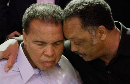 Rev. Jesse Jackson and Muhammad Ali hugging on camera