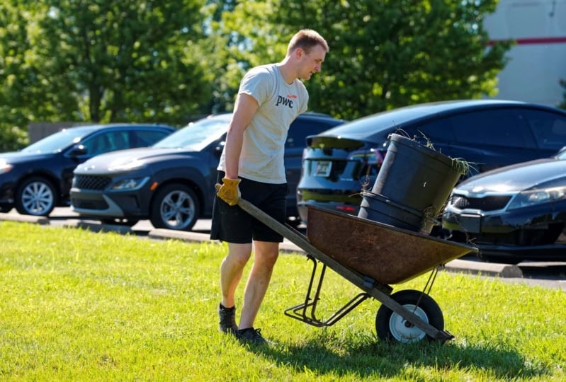 person pushing lawn equipment