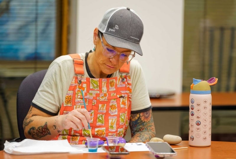 person painting rock for encouragement