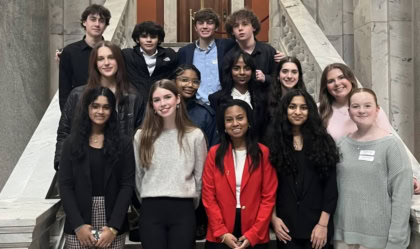 Photo of high school students on the steps of the Kentucky State Capitol smiling at camera