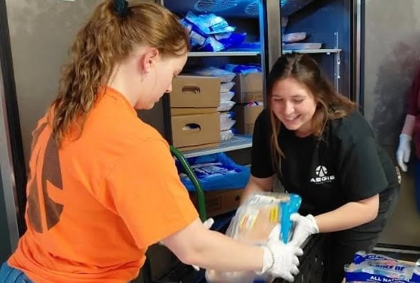 People packing up bags of food