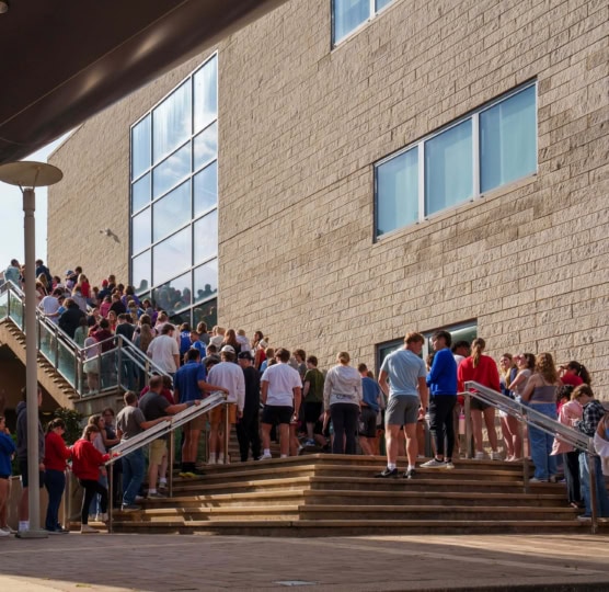 Group of students standing outside Ali Center on staircase