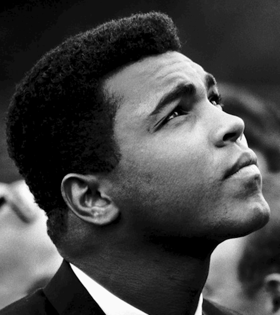 Photo of Muhammad Ali in black and white looking up off camera