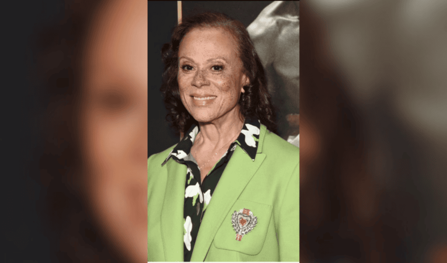 Photo of Lonnie Ali wearing green jacket smiling at camera